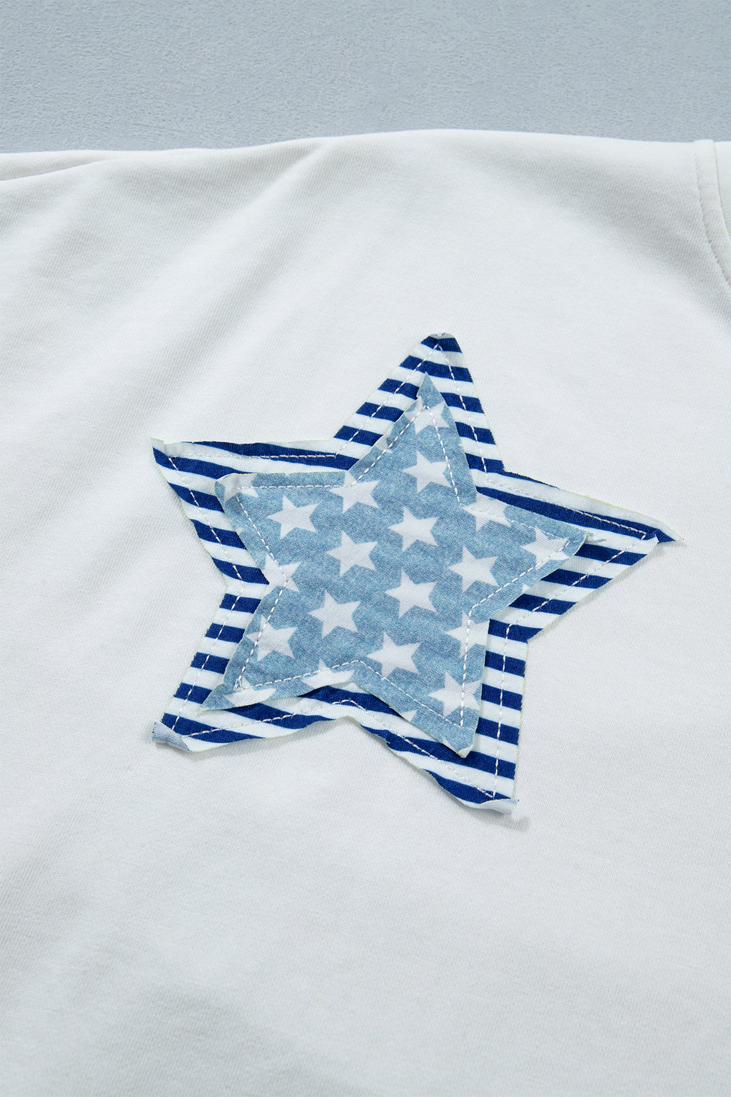 Shop White & Sky Blue Star Patch Notched Neck Mineral Wash Dolman Tee at LivelyLooks
