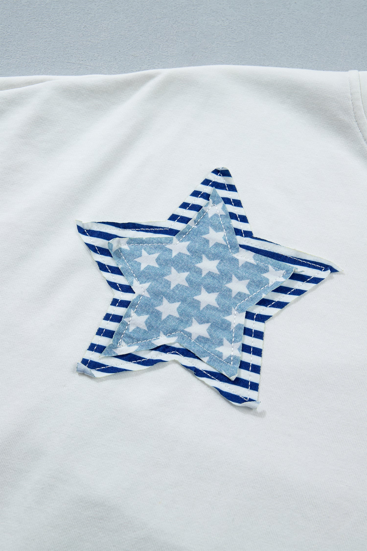Shop White & Sky Blue Star Patch Notched Neck Mineral Wash Dolman Tee at LivelyLooks